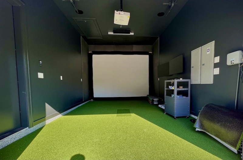 Golf simulator enclosure with impact screen